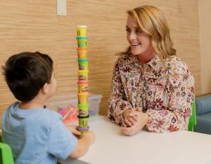 Speech therapist working with a child using play-based activities